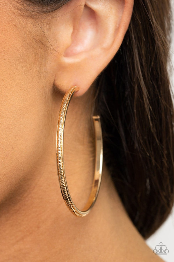 ﻿Sultry Shimmer-Gold Paparazzi Earrings-Jazzi Jewelz Boutique by Raven  Featuring shimmery diamond-cut texture, a glistening gold bar lines the center of a beveled gold hoop, creating an edgy stacked look. Earring attaches to a standard post fitting. Hoop measures approximately 2 1/2