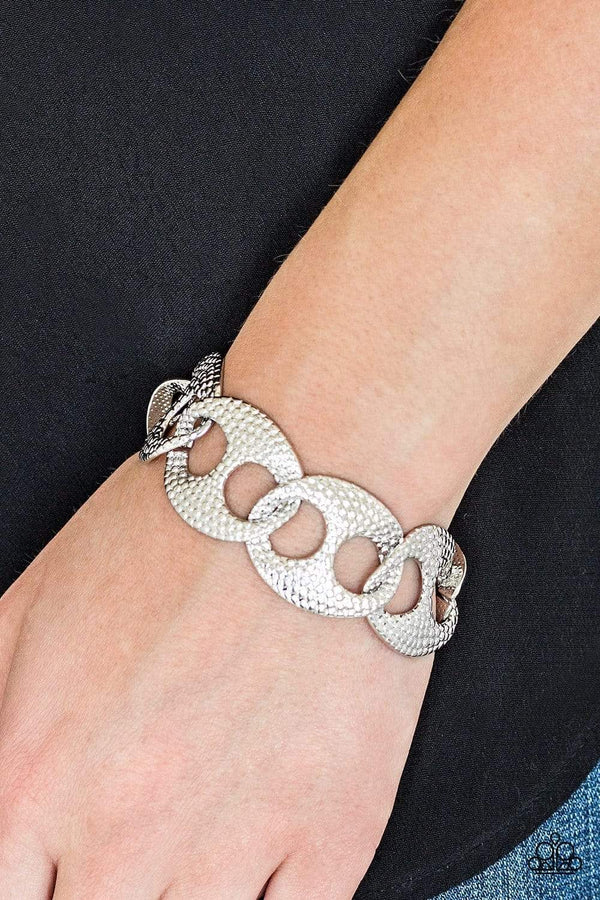  Shop Our Stunning ﻿Casual Connoisseur-Silver Bracelet Embossed in shimmery circular patterns, asymmetrical silver frames link across the wrist for a casually industrial look.