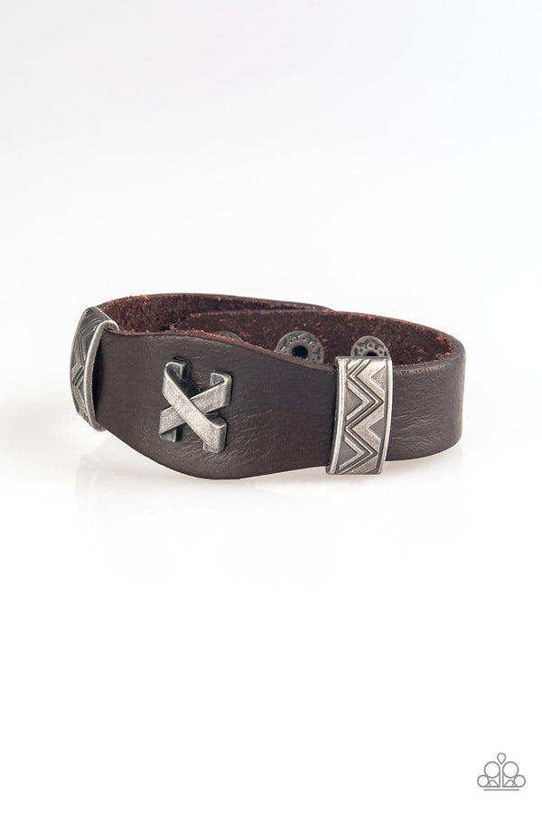 Tread Carefully-Brown Leather Bracelet-Jazzi Jewelz Boutique by Raven  Featuring ornate metallic accents, an antiqued crisscross frame embellishes the center of a brown leather band for an edgy urban look. Features an adjustable snap closure.  Sold as one individual bracelet.