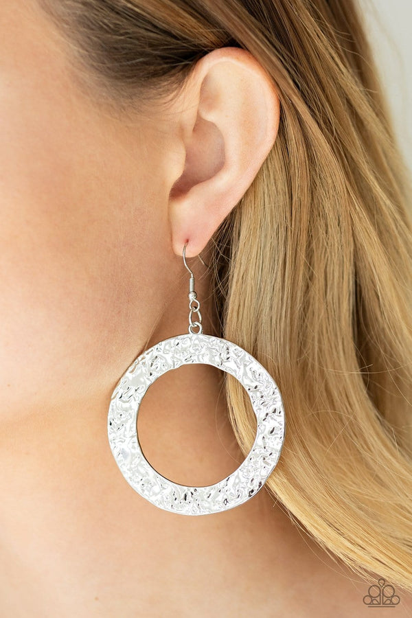 PRIMAL Meridian-Silver Paparazzi Earrings-Jazzi Jewelz Boutique by Raven  Brushed in a rustic silver finish, a flat circular frame has been hammered in blinding detail for a handcrafted look. Earring attaches to a standard fishhook fitting.  Sold as one pair of earrings.  All Paparazzi Accessories are lead free and nickel free.