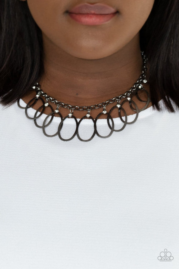 Double Oval-time-Black Paparazzi Necklace-Jazzi Jewelz Boutique by Raven  Hammered in a shiny matte finish, flat gunmetal oval frames swing from the bottom of a bold gunmetal chain below the collar. Glassy white rhinestones adorn the oval frames, adding a flawless hint of sparkle to the flattering fringe. Features an adjustable clasp closure.  Sold as one individual necklace. Includes one pair of matching earrings.  All Paparazzi Accessories are 100% lead free and nickel free. 