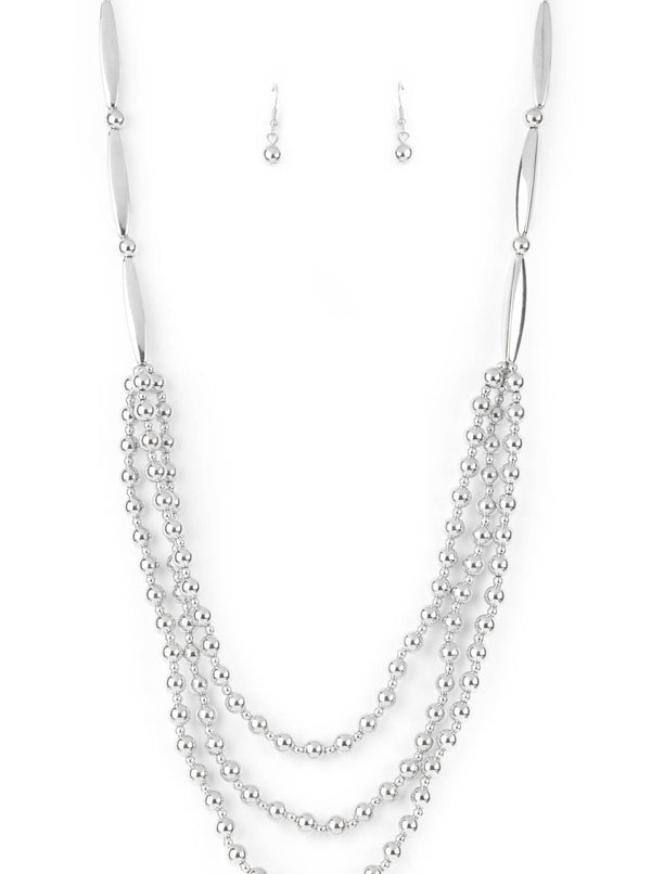 Beaded Beacon-Silver Paparazzi Necklace-Jazzi Jewelz Boutique by Raven  Brushed in a shiny shimmer, dainty and classic silver beads alternate across the chest in three gleaming layers. The tiered display attaches to oblong and classic silver beads that connect to a silver chain for a bold industrial statement. Features an adjustable clasp closure.  Sold as one individual necklace. Includes one pair of matching earrings.  All Paparazzi Accessories are 100% lead free and nickel free.