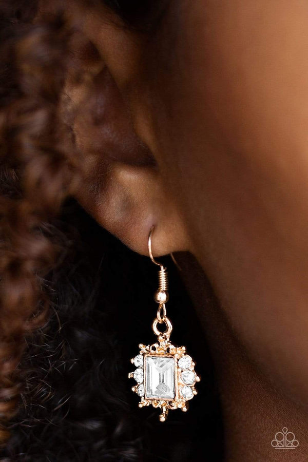 Can't Stop the Reign Gold EarringsCan't Stop The Reign-Gold Paparazzi Earrings  Featuring a regal emerald style cut, a glittery white gem is pressed into a shimmery gold frame radiating with  rhinestones for a refined look. Earring attaches to a standard fishhook fitting.  Paparazzi Accessories Are 100% Lead Free & Nickel Free.