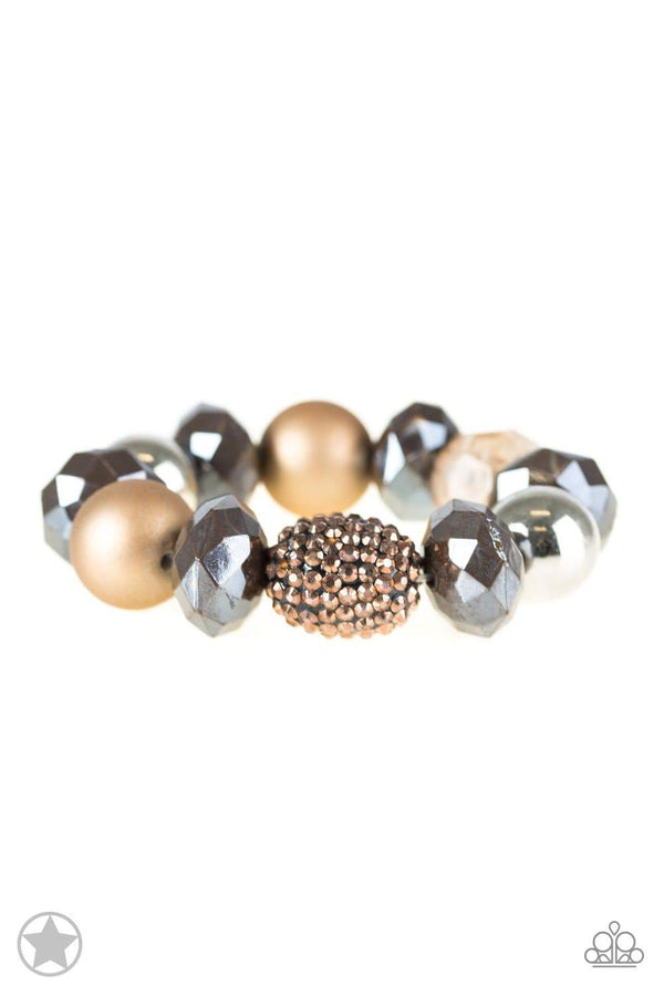﻿All Cozied Up-Copper Paparazzi Bracelet-Jazzi Jewelz Boutique by Raven   Silver based bracelet with warm beads in shades of brown and copper bracelet with reflective faceted edges and varying glazed finishes are offset by two shiny silver beads. An oblong bead studded with copper-toned rhinestones adds a dramatic accent.  Paparazzi Jewelry are always lead free and nickel free. 