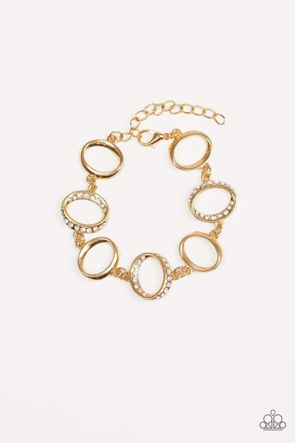 ﻿Beautiful Inside And Out-Gold Paparazzi Bracelet-Jazzi Jewelz Boutique by Raven  Glistening gold hoops link with white rhinestone encrusted hoops around the wrist for a timeless shine. Features an adjustable clasp closure. Sold as one individual bracelet.  All Paparazzi Jewelry is 100% lead free and nickel free. 
