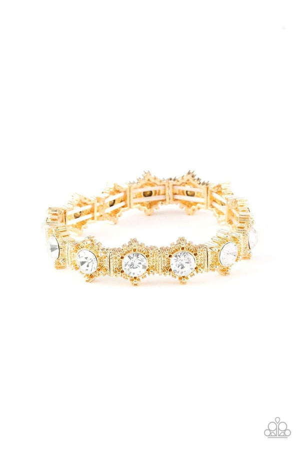 Strut Your Stuff-Gold Bracelet-Jazzi Jewelz Boutique by Raven   Featuring glittery white rhinestone centers, ornate golden frames are threaded along stretchy bands, linking across the wrist for a refined look. Sold as one individual bracelet.  All Paparazzi Jewelry is lead free and nickel free. 