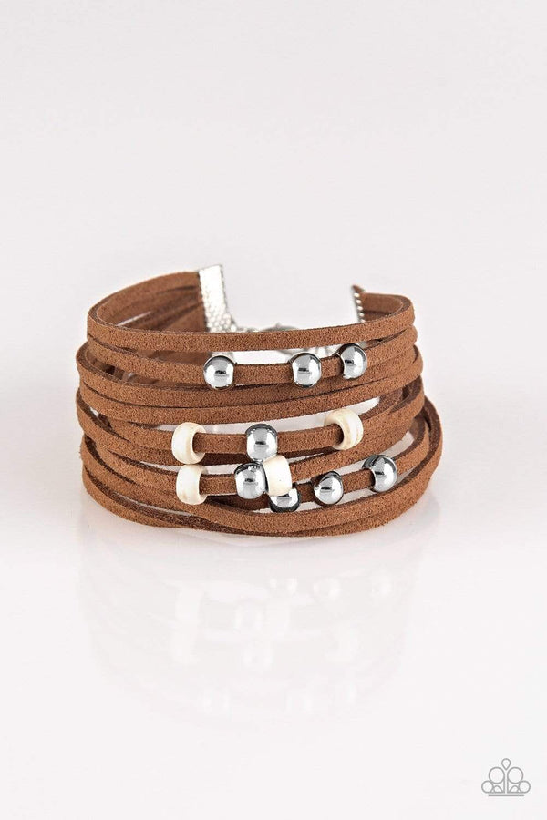 Colorfully Coachella-Brown Paparazzi Bracelet-Jazzi Jewelz Boutique by Raven   Dainty white wooden beads and classic silver beads are threaded along strands of brown suede, creating colorful layers across the wrist. Features an adjustable clasp closure.  Sold as one individual bracelet.  Paparazzi Jewelry is 100% lead free and nickel free. 