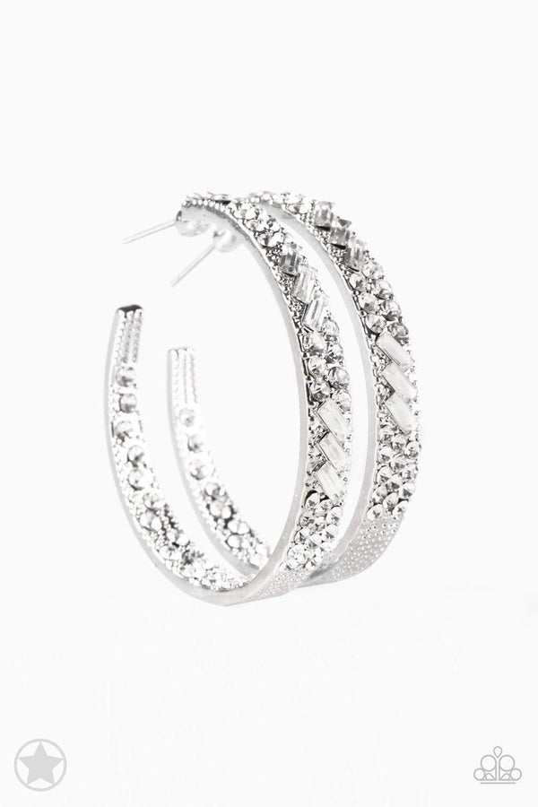 Glitzy by Association Rhinestone Paparazzi Earrings-Jazzi Jewelz Boutique by Raven The front facing surface of a chunky silver hoop is dipped in brilliantly sparkling rhinestones while light-catching texture wraps around the back. The interior of the hoop features the opposite pattern, creating the illusion of a full hoop of blinding rhinestones. Earring attaches to a standard post fitting. Hoop measures 1 3/4" in diameter. Paparazzi Jewelry is always lead free and nickel free. 