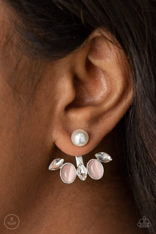 Modern Sophistication-Pink Pearl Paparazzi Earrings-Jazzi Jewelz Boutique by Raven﻿    A solitaire white pearl attaches to a double-sided post, designed to fasten behind the ear. Encrusted in a fringe of glassy white rhinestones and glowing pink cat's eye stones, the angular double-side post peeks out beneath the ear for a refined look. Earring attaches to a standard post fitting.  Sold as one pair of double-sided post earrings.   Paparazzi Accessories are 100% lead free and nickel free. 