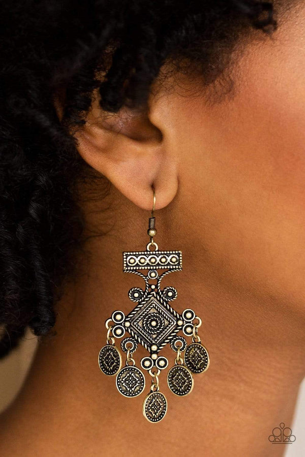 ﻿Unexplored Lands-Brass Paparazzi Earrings-Jazzi Jewelz Boutique by Raven  Radiating with tribal inspired details, brass coin-like discs swing from the bottom of an ornate brass frame, creating a whimsical fringe. Earring attaches to a standard fishhook fitting.  Sold as one pair of earrings.